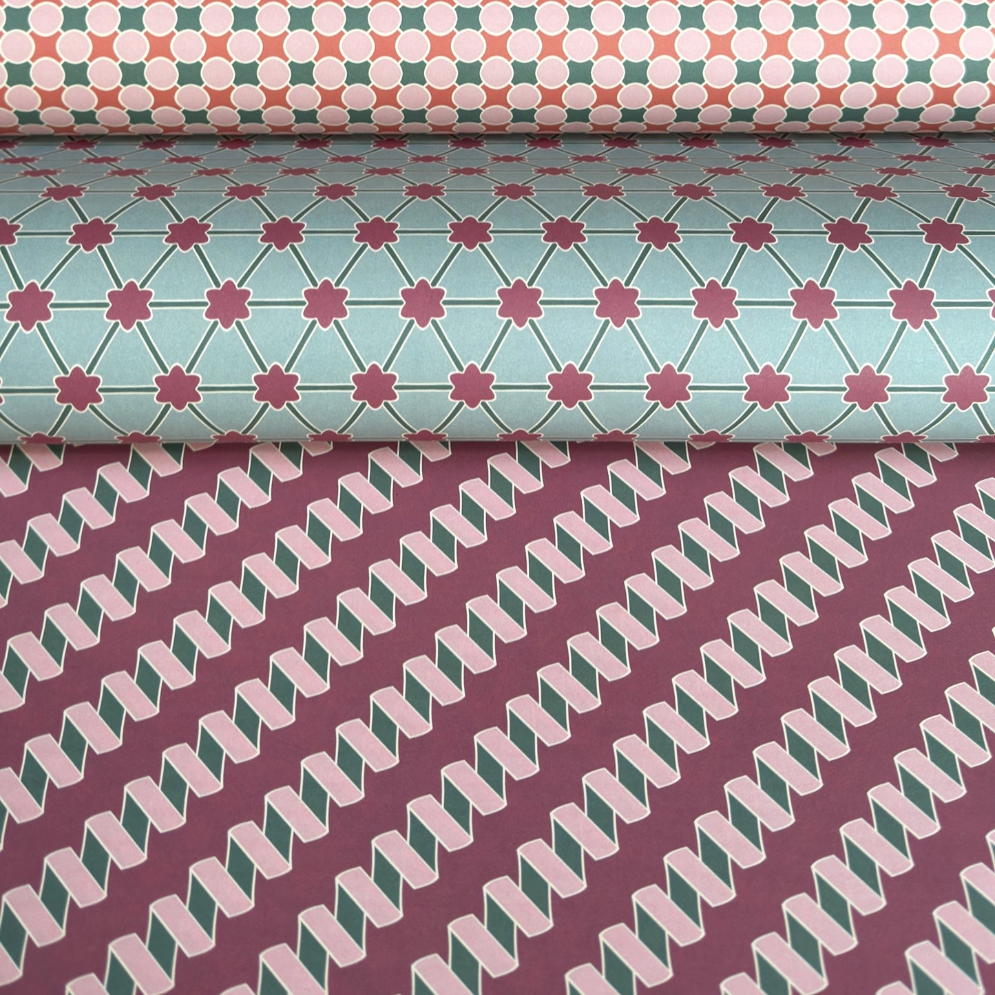 three sheets of geometric wrapping papers with different desings