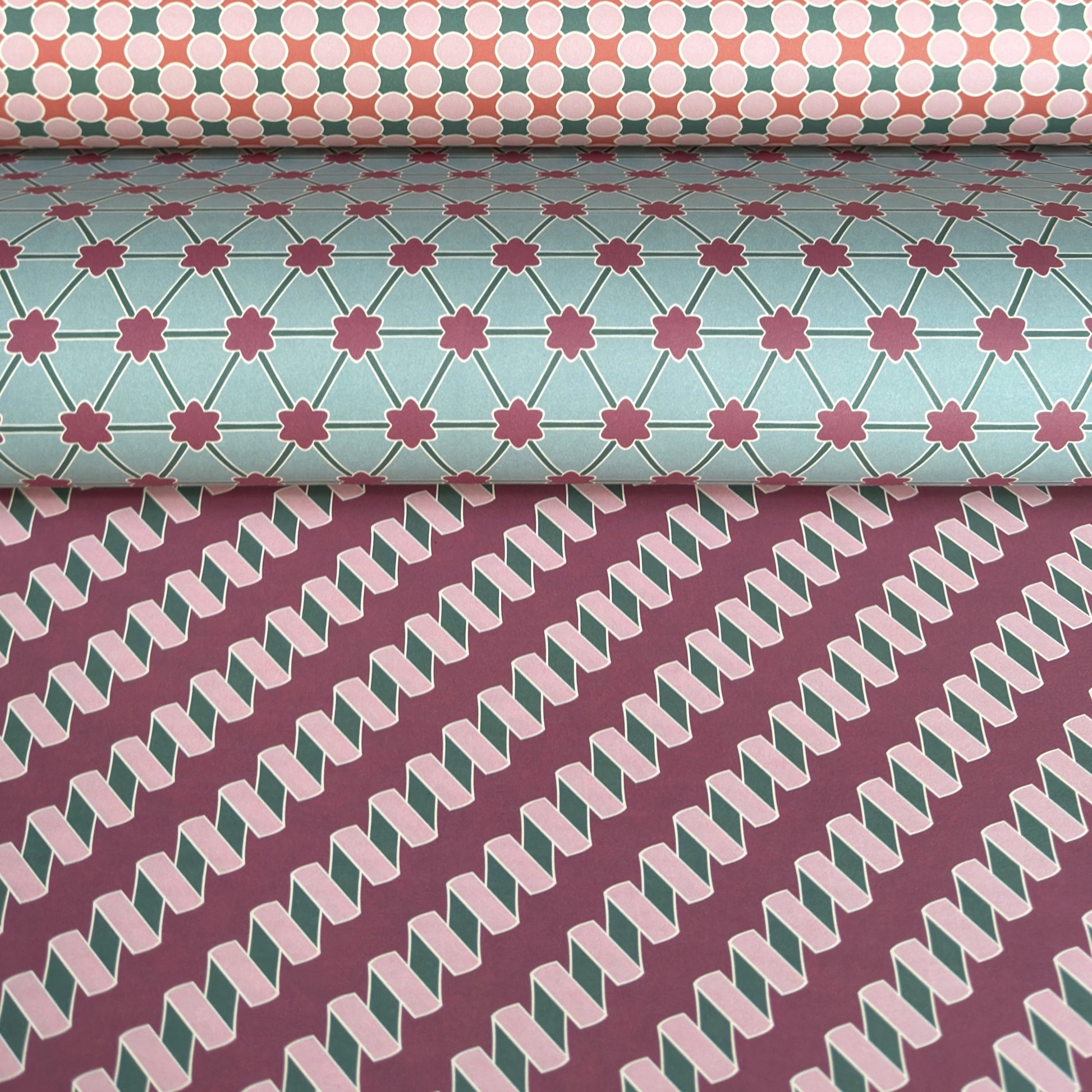 three sheets of geometric wrapping papers with different desings