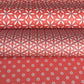 Three rolls of red wrapping paper with geometric patterns