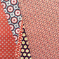 five sheets of different geometric wrapping papers in colours of red, purple and white
