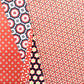 Patterned wrapping paper with various designs on a red background