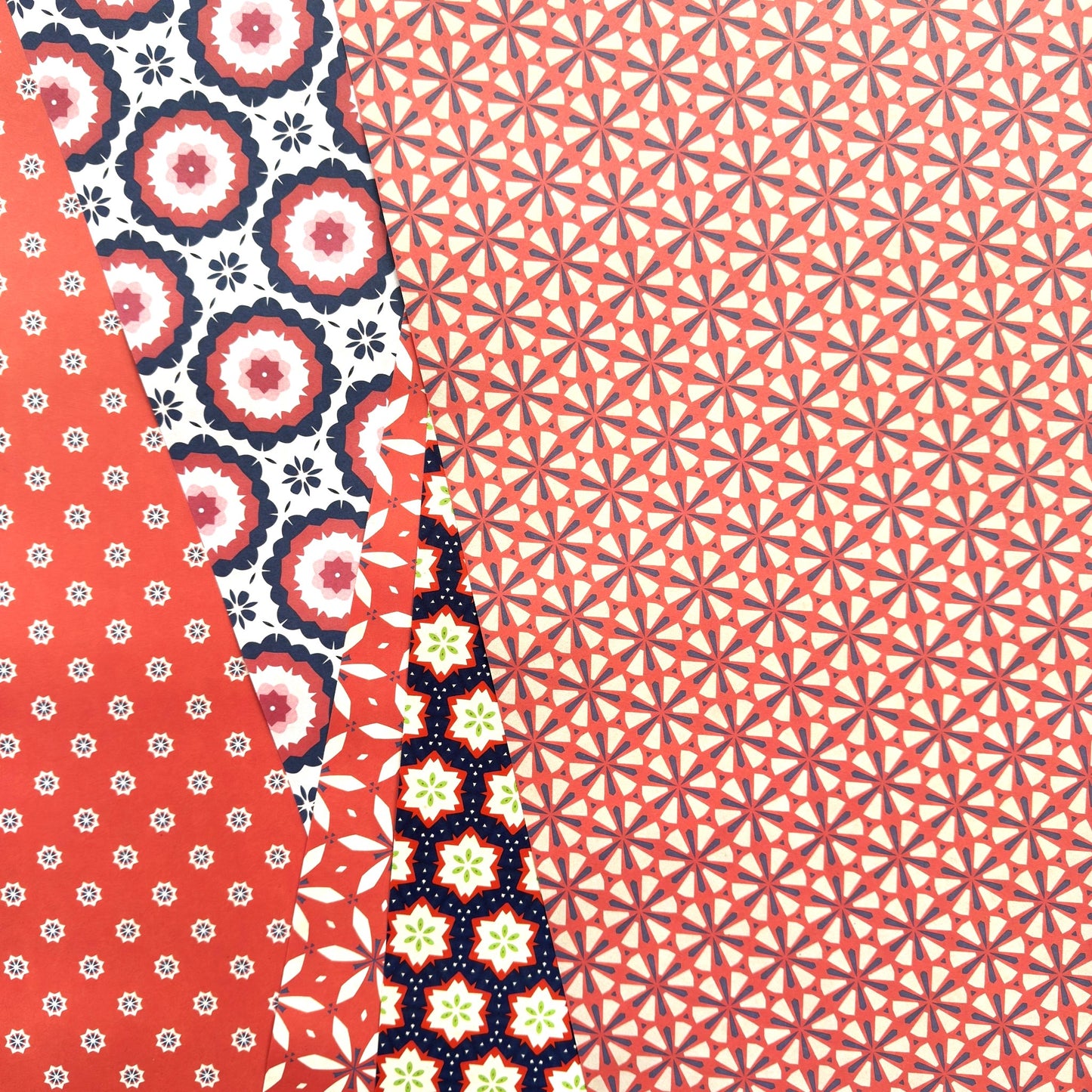 Patterned wrapping paper with various designs on a red background