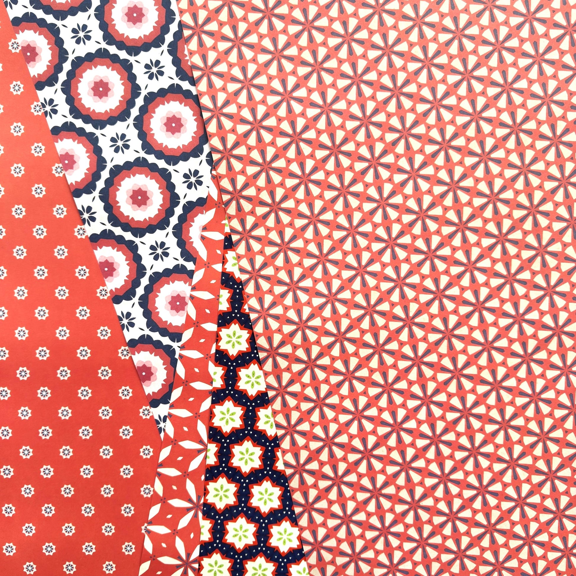 Patterned wrapping paper with various designs on a red background