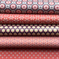 Stack of rolls of wrapping paper with various geometric patterns
