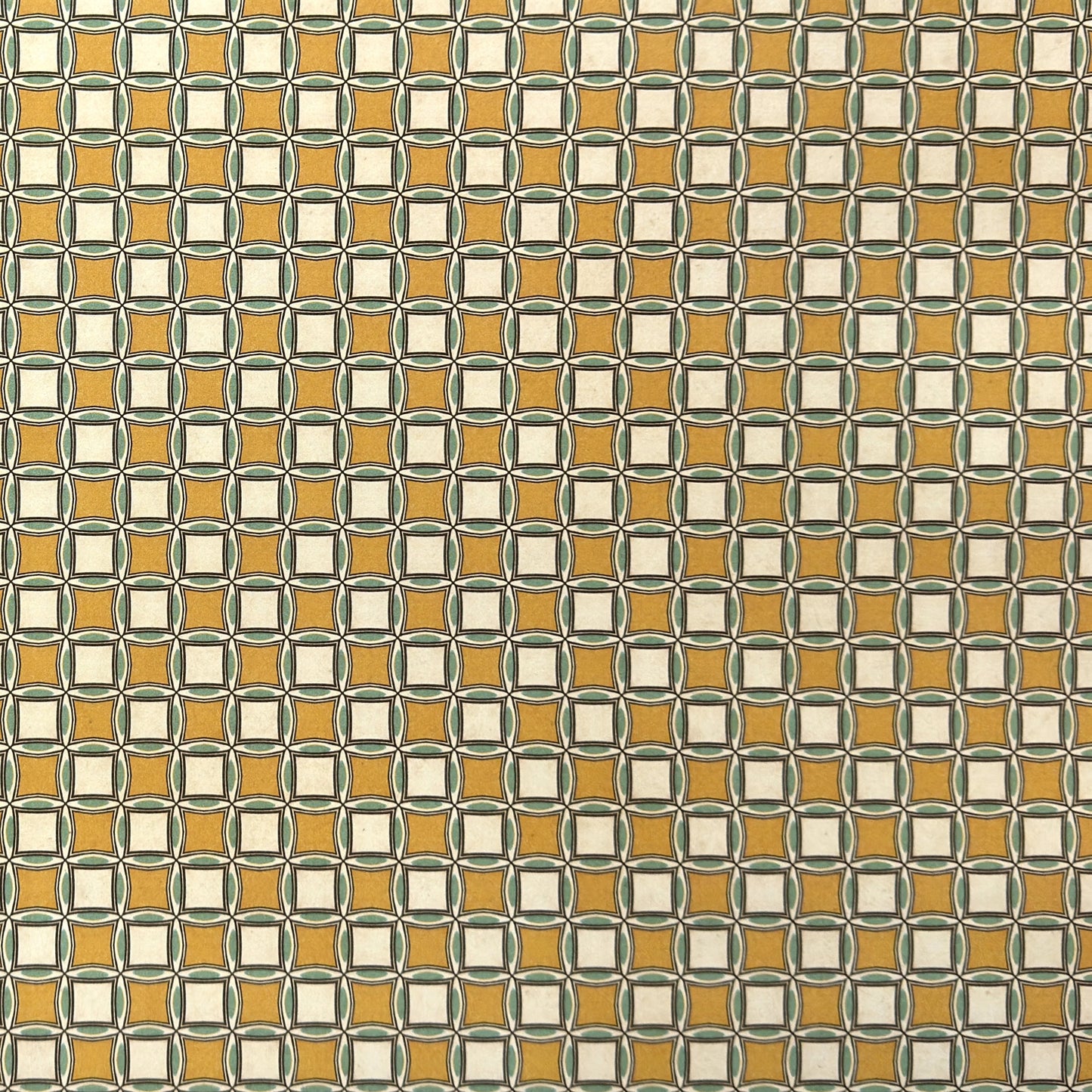 Patterned wrapping paper with geometric design in yellow, white, and green.