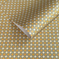 Patterned wrapping paper with geometric design in yellow, white, and green.