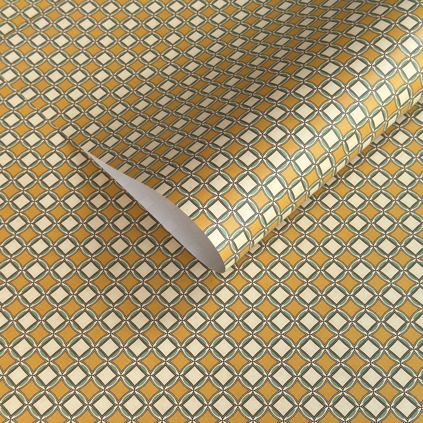 Patterned wrapping paper with geometric design in yellow, white, and green.
