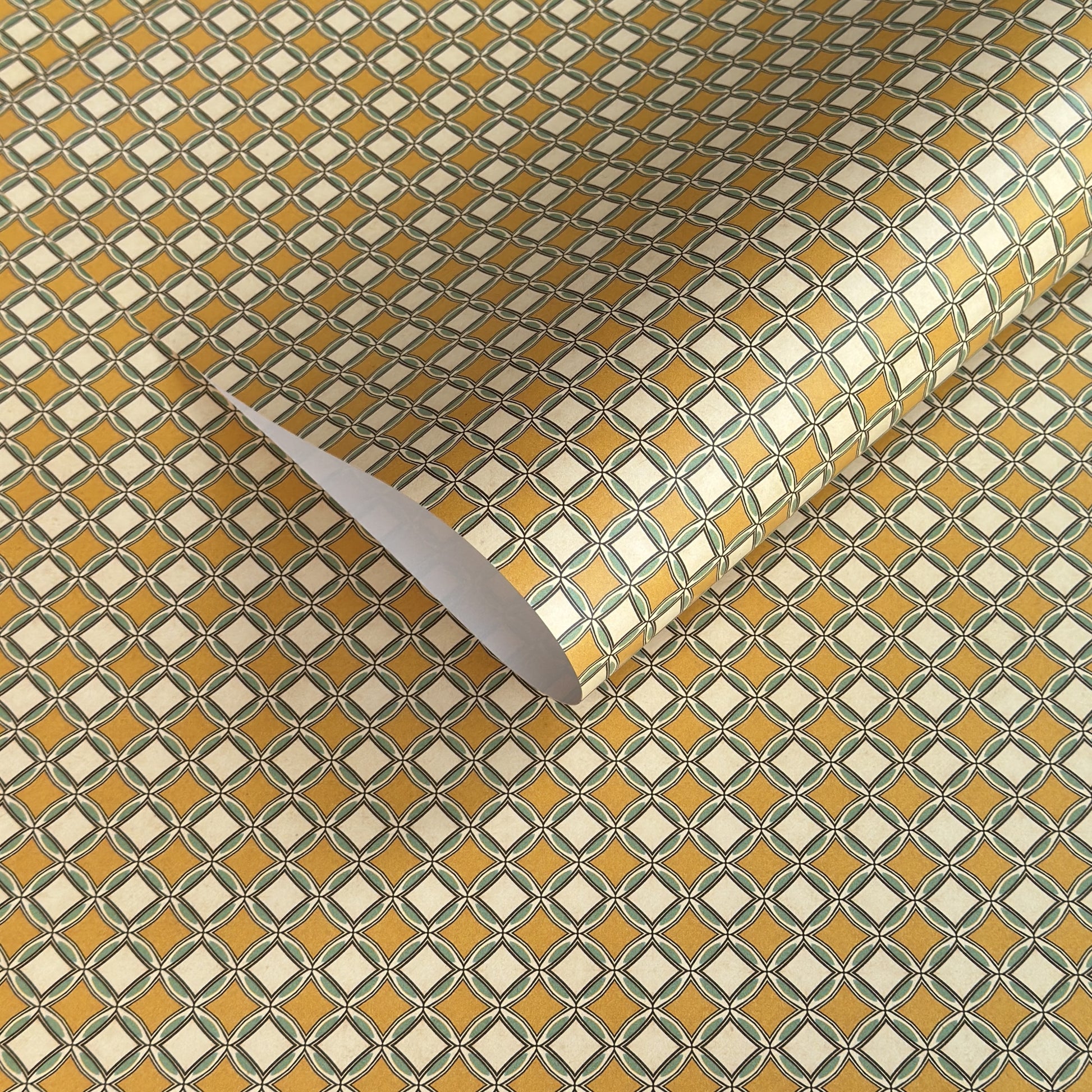 Patterned wrapping paper with geometric design in yellow, white, and green.