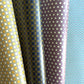 Four rolls of patterned paper with different designs.