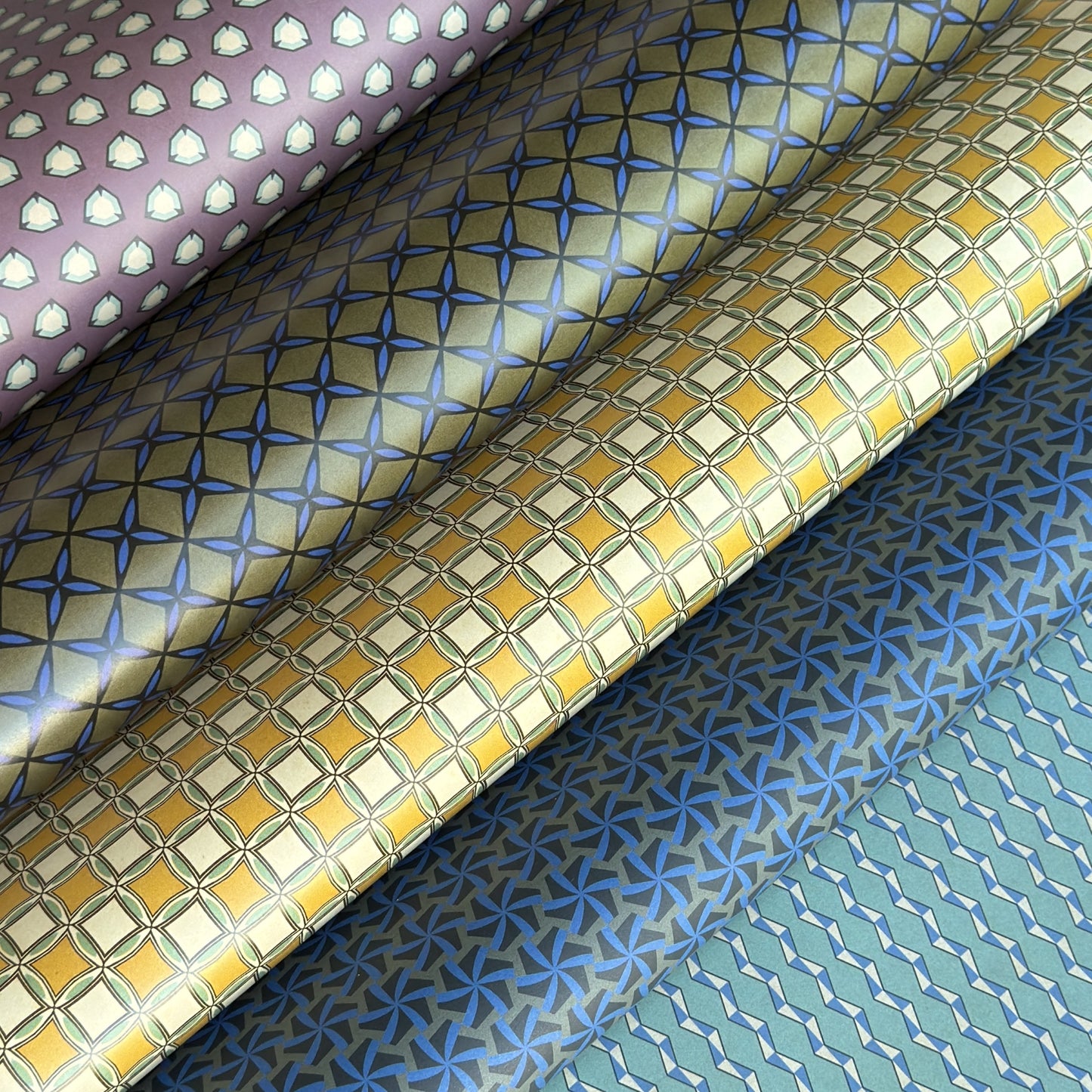Five patterned wrapping papers with geometric designs.