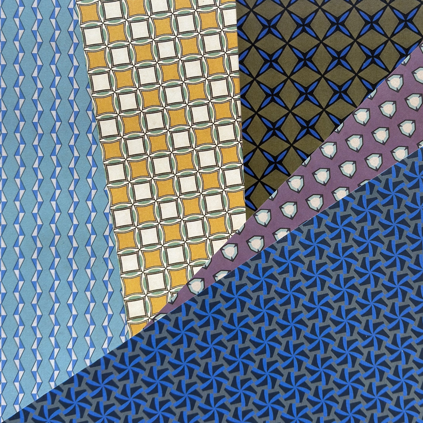 Collection of various geometric patterned papers in different colors.