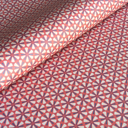 a sheet of geometric paper in red, purple and white