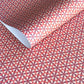 a sheet of geometric paper in red, purple and white