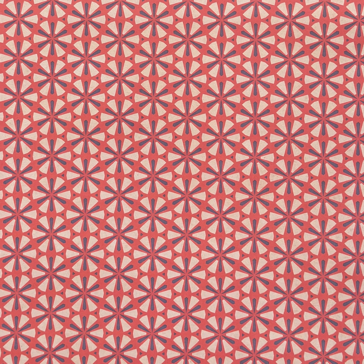 a sheet of geometric paper in red, purple and white