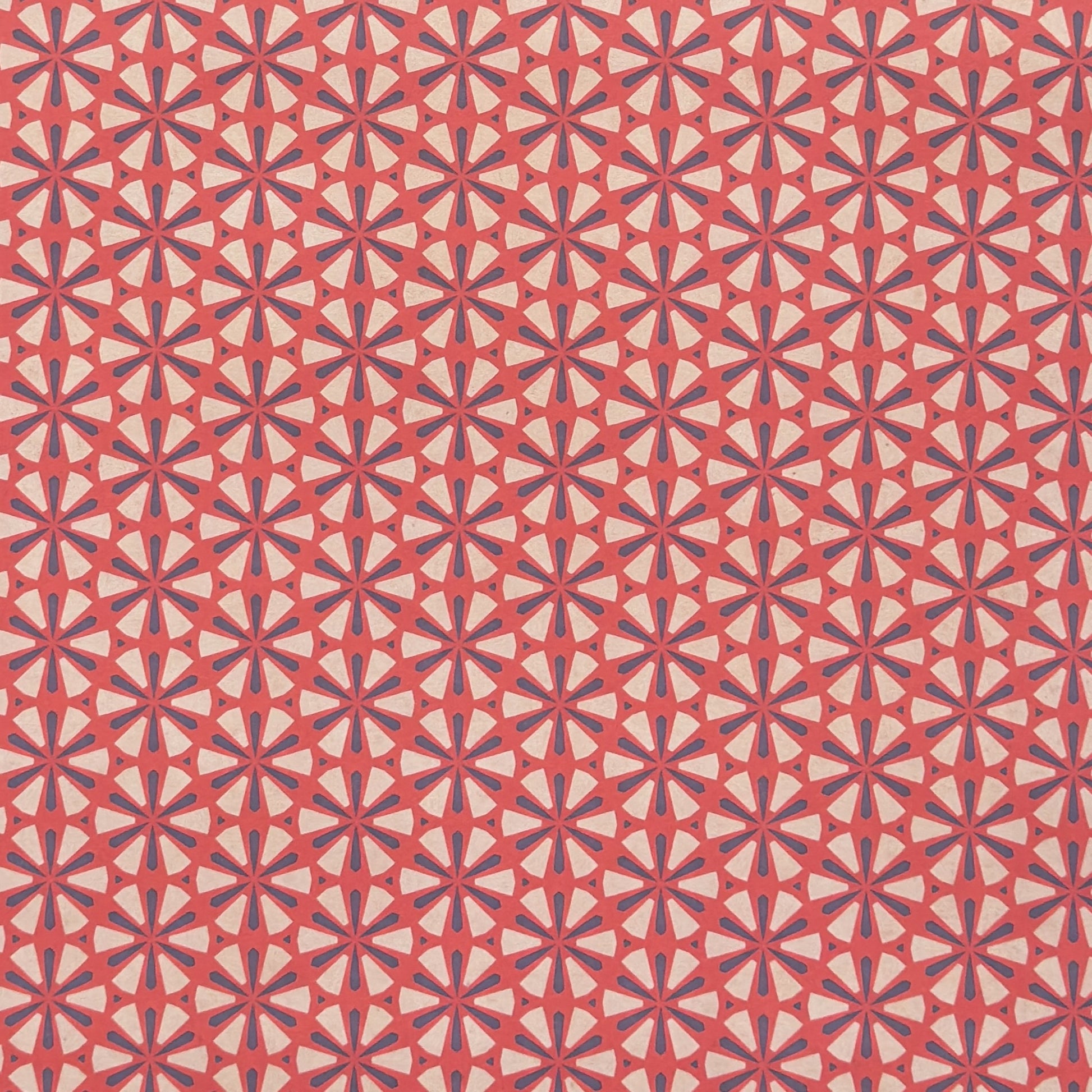 a sheet of geometric paper in red, purple and white
