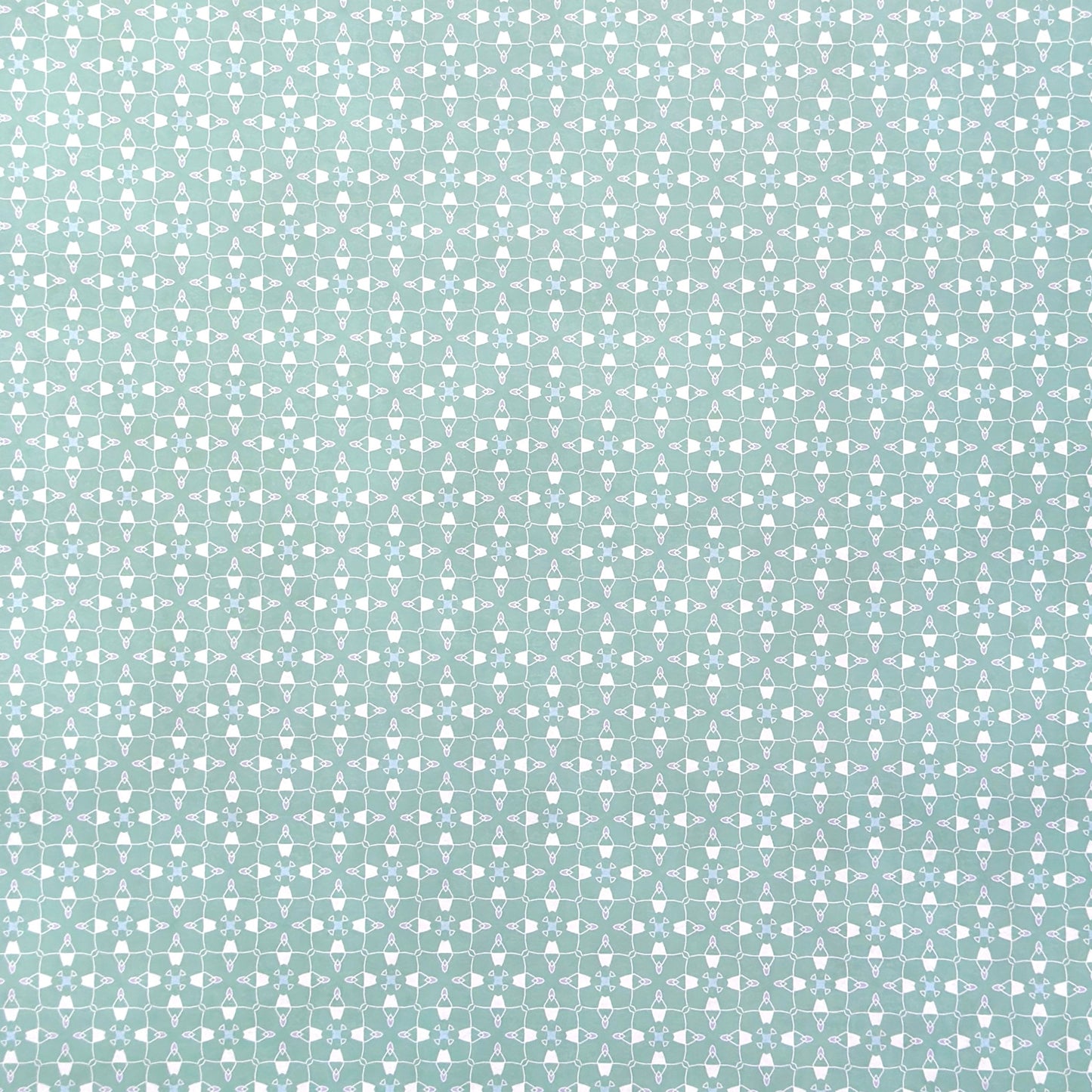 a sheet of wrapping paper with a geometric design on aqua backdrop