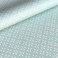a sheet of wrapping paper with a geometric design on aqua backdrop