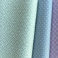 Three wrapping papers in green, blue, and purple with geometric patterns.