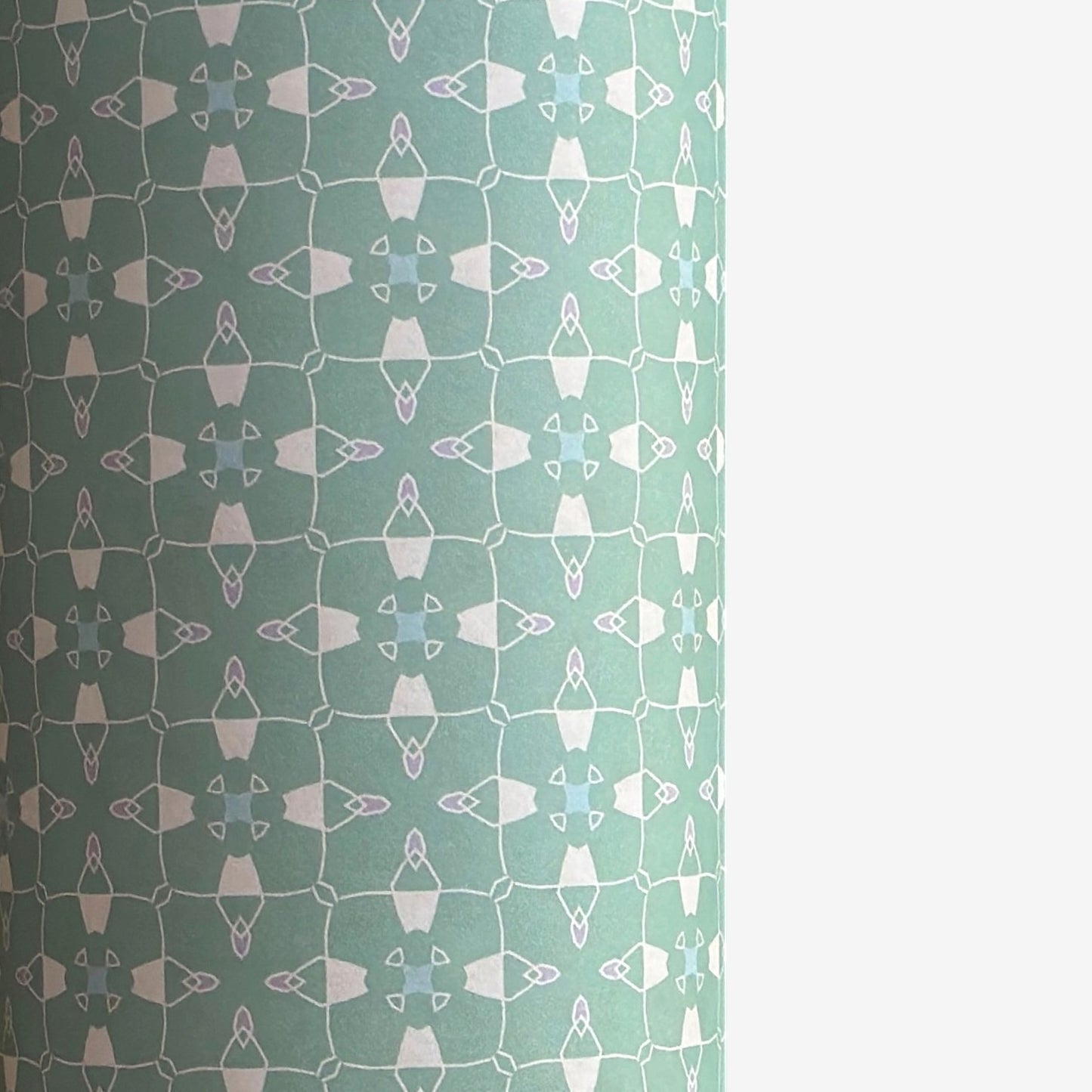 a sheet of wrapping paper with a geometric design on aqua backdrop
