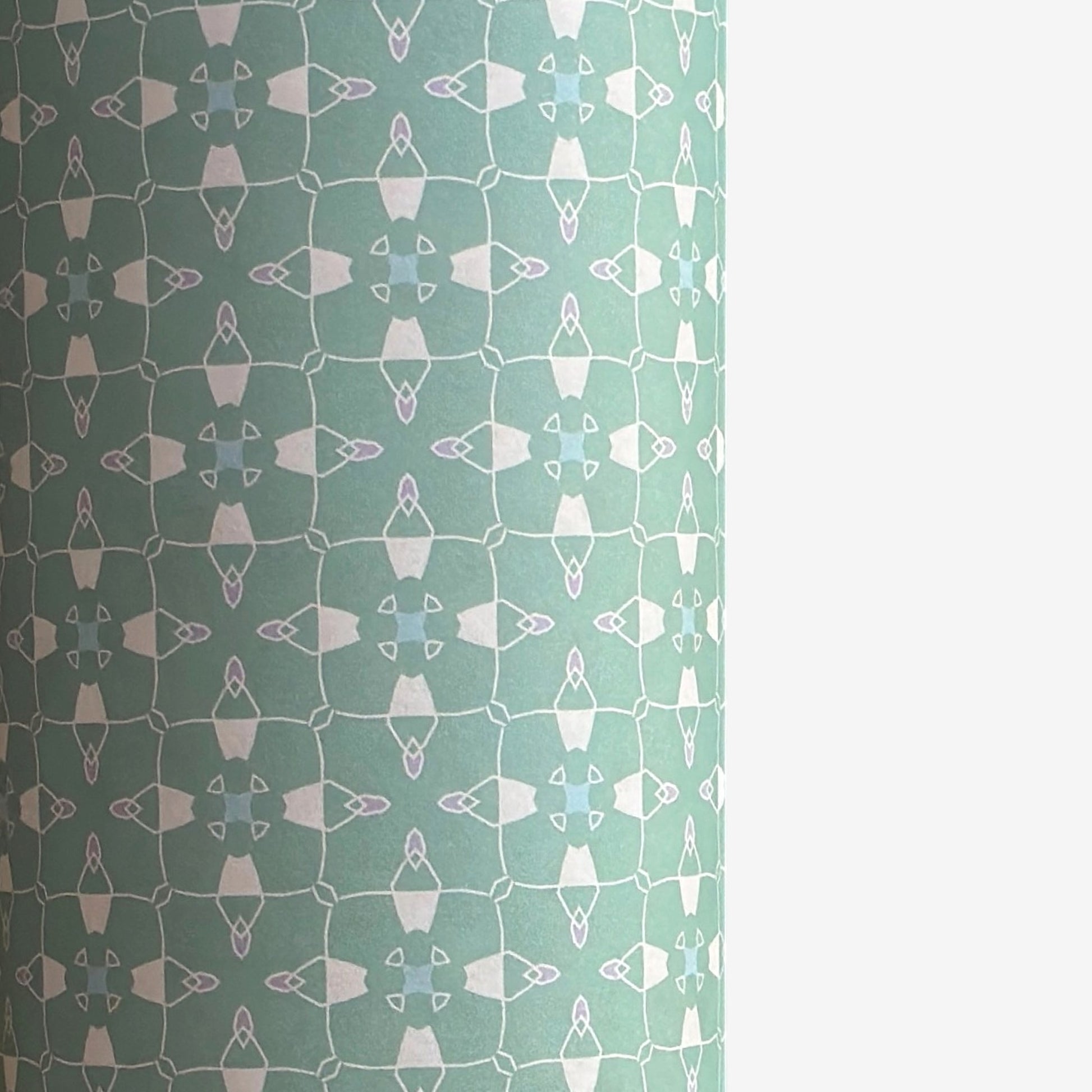 a sheet of wrapping paper with a geometric design on aqua backdrop