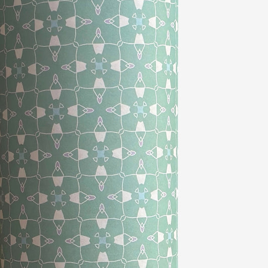 a sheet of wrapping paper with a geometric design on aqua backdrop