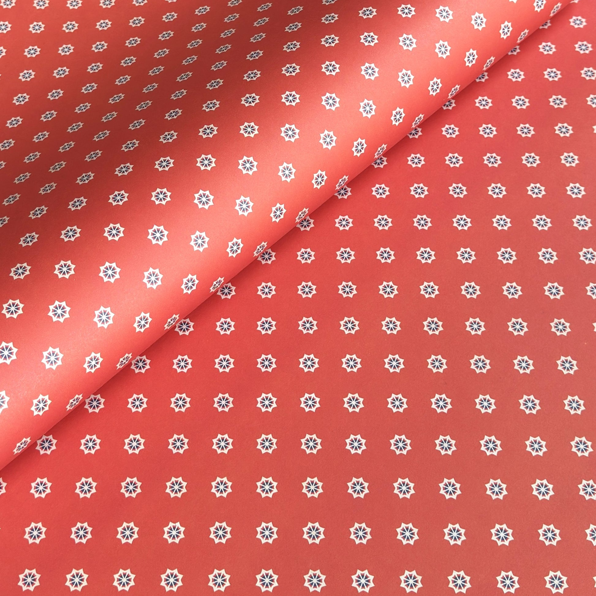 Red wrapping paper with white star floral pattern