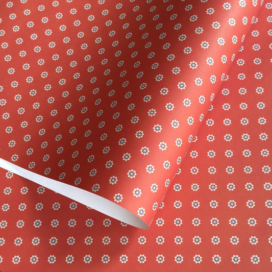 Red wrapping paper with white star floral pattern