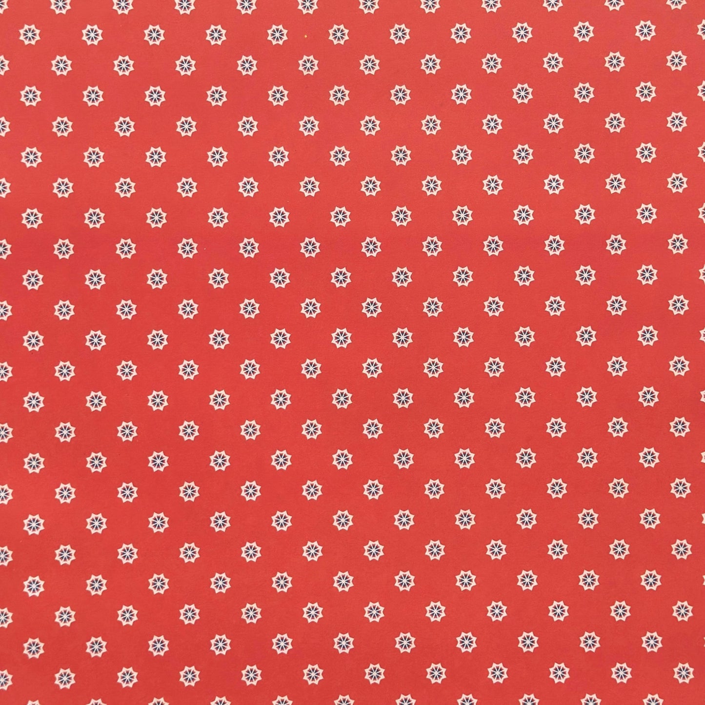 Red wrapping paper with white star floral pattern