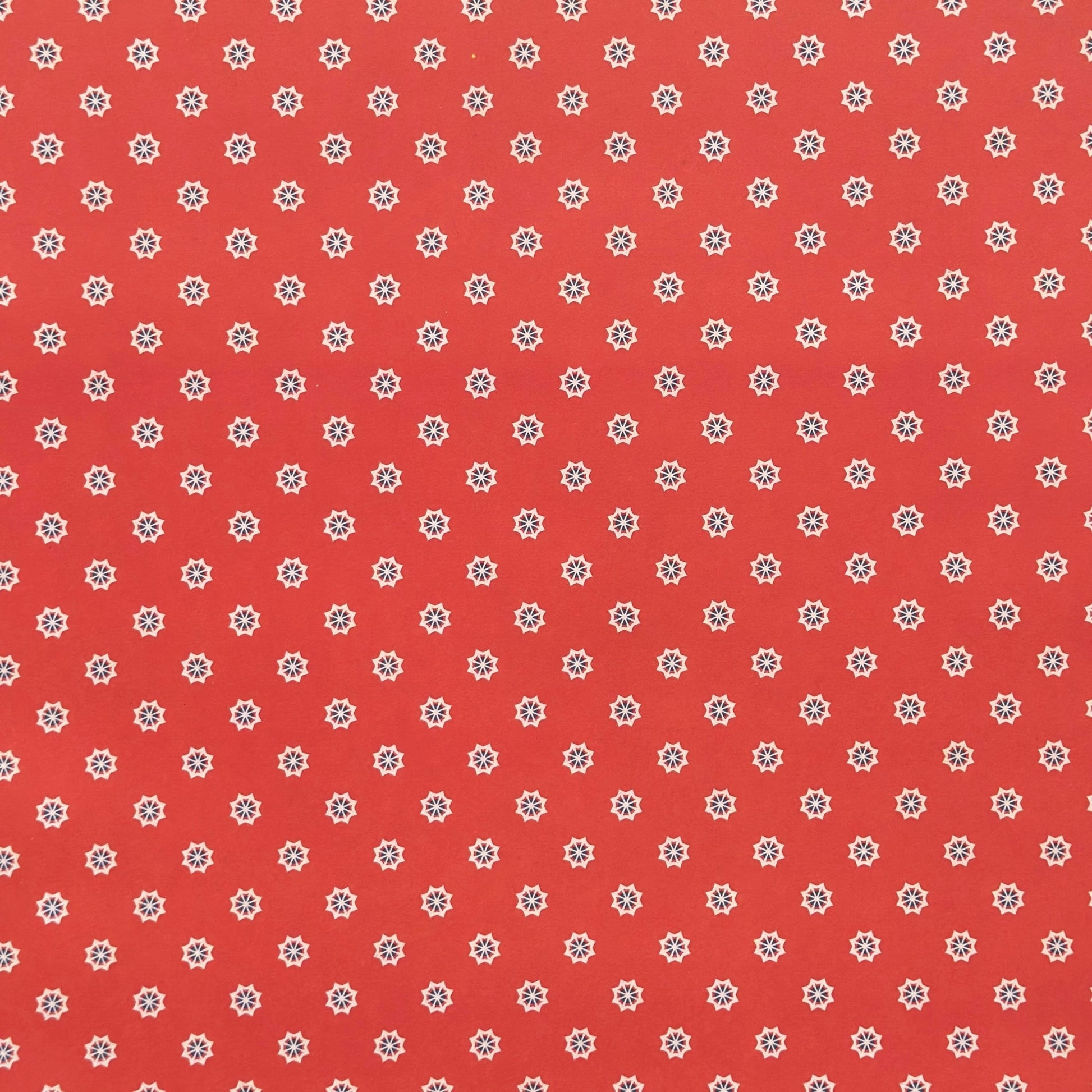 Red wrapping paper with white star floral pattern