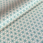wrapping paper with a geometric pattern in green and yellow on beige