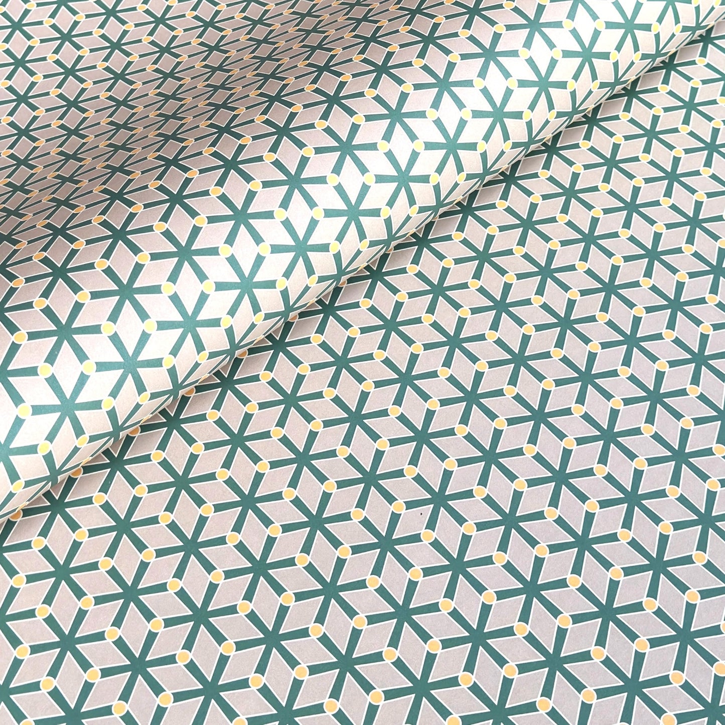 wrapping paper with a geometric pattern in green and yellow on beige