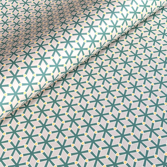 wrapping paper with a geometric pattern in green and yellow on beige