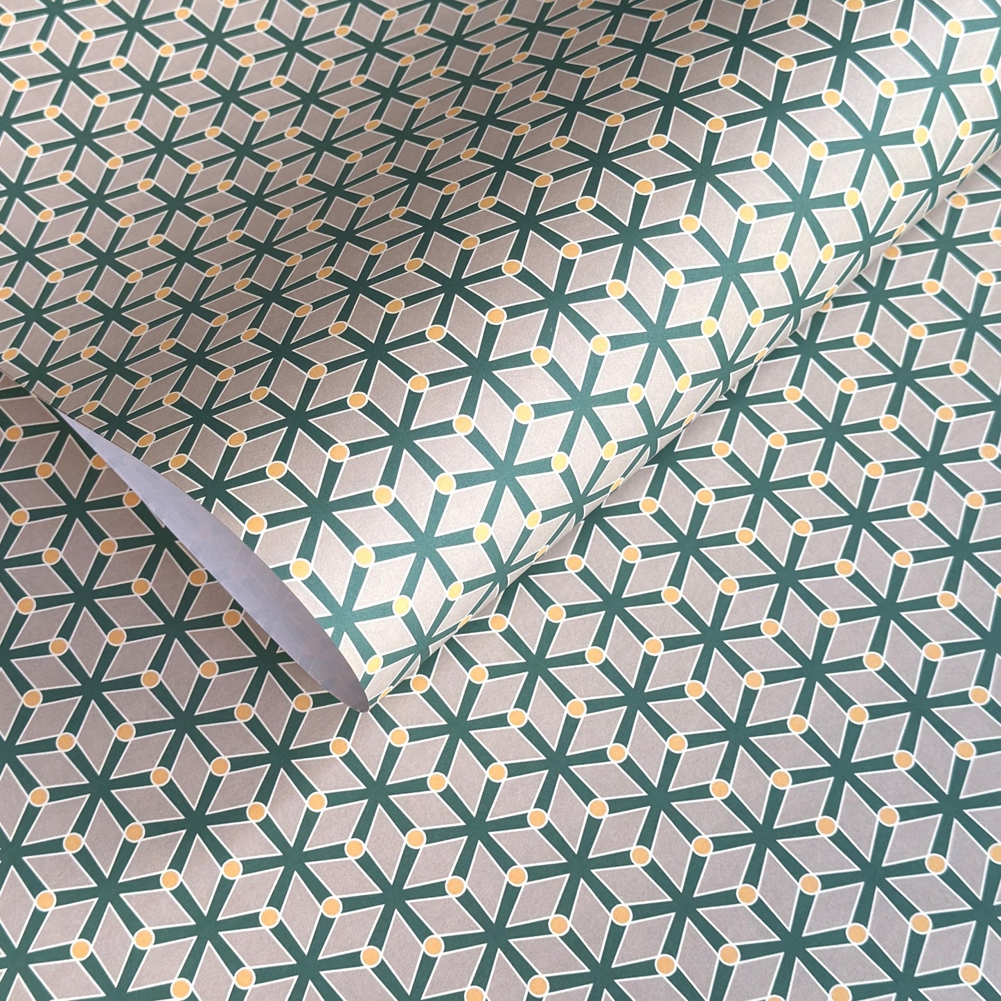 wrapping paper with a geometric pattern in green and yellow on beige