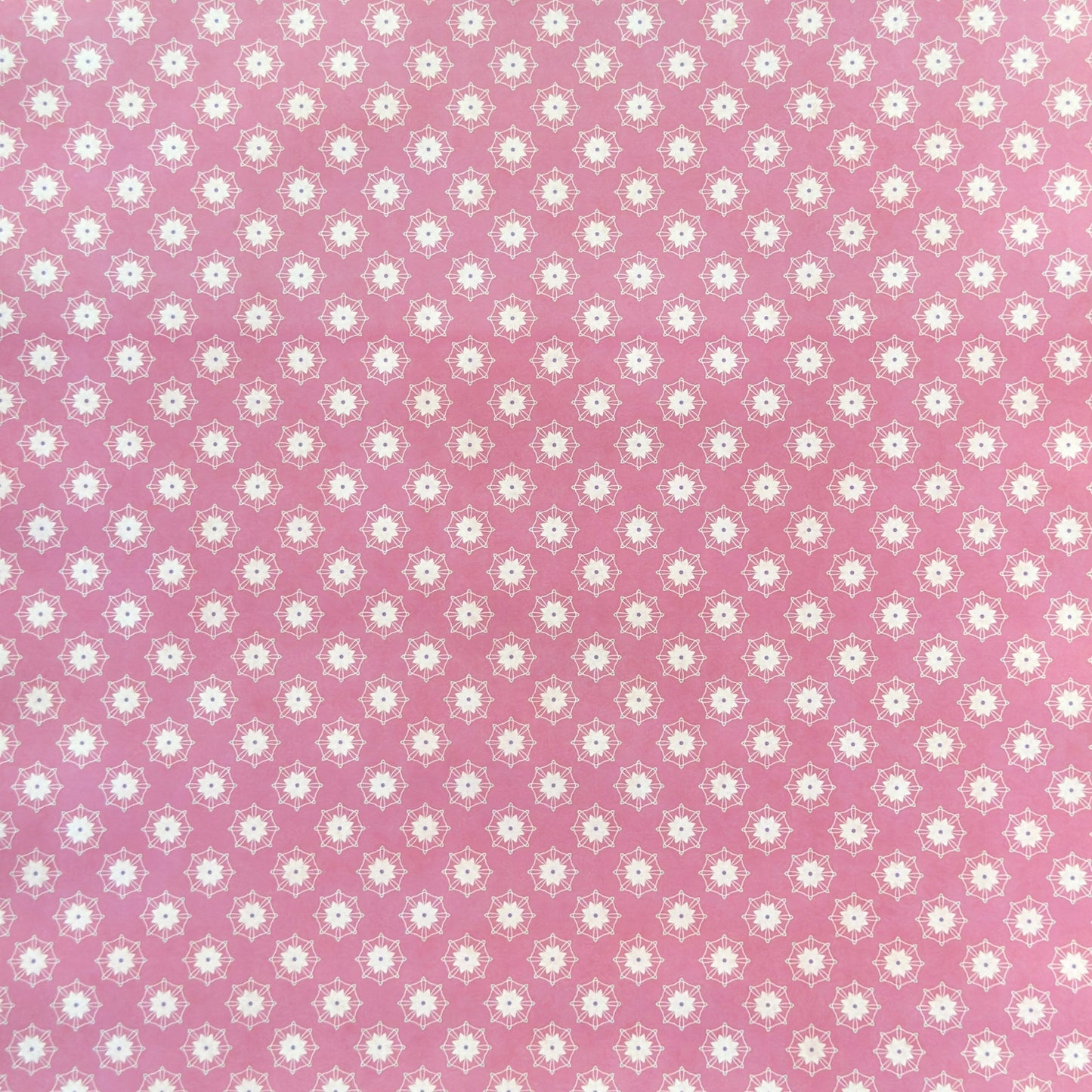 Pink wrapping paper with white floral geometric pattern