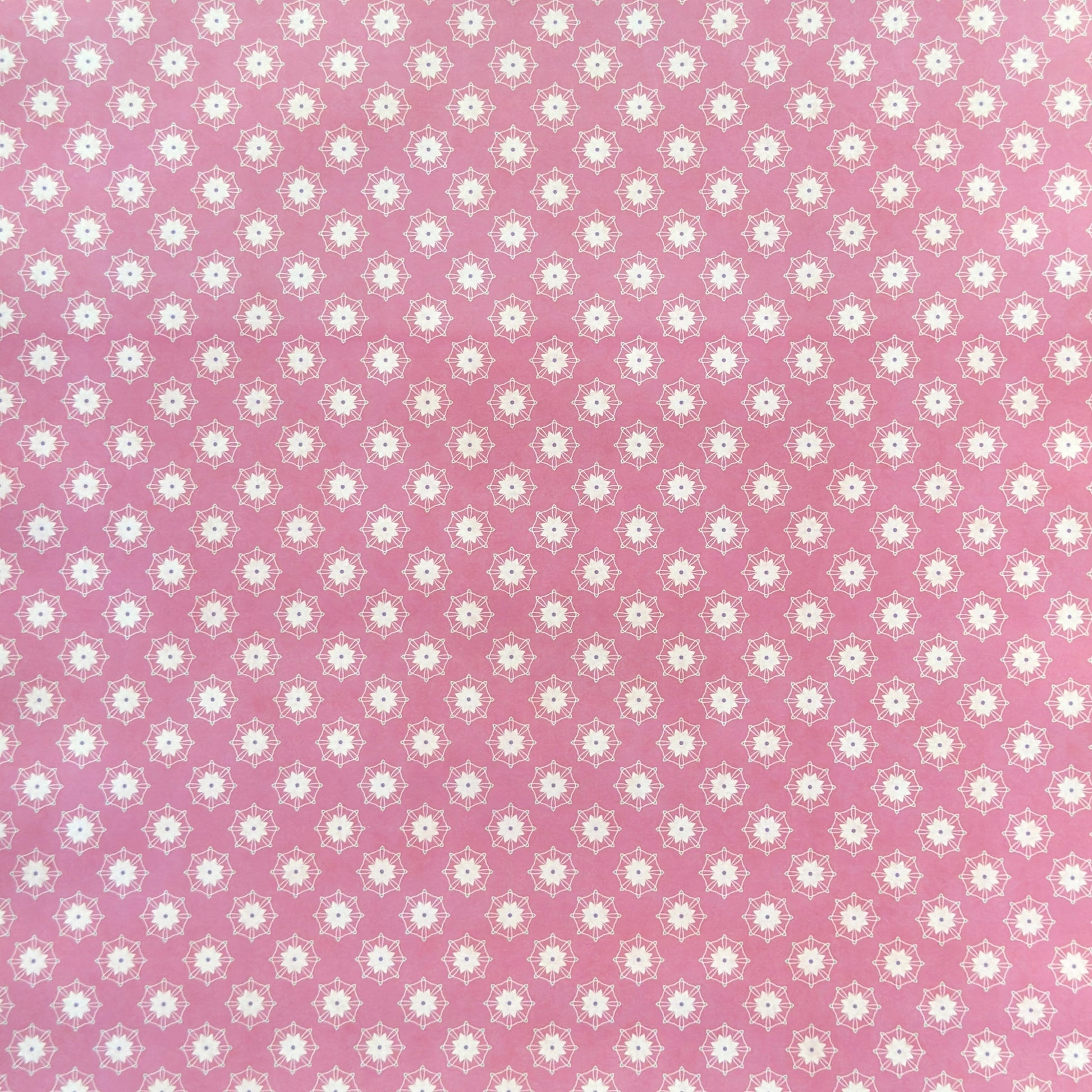 Pink wrapping paper with white floral geometric pattern
