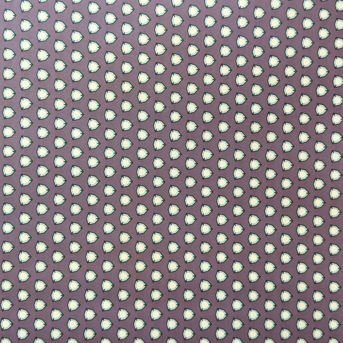 purple wrapping paper with a geometric pattern in white and black