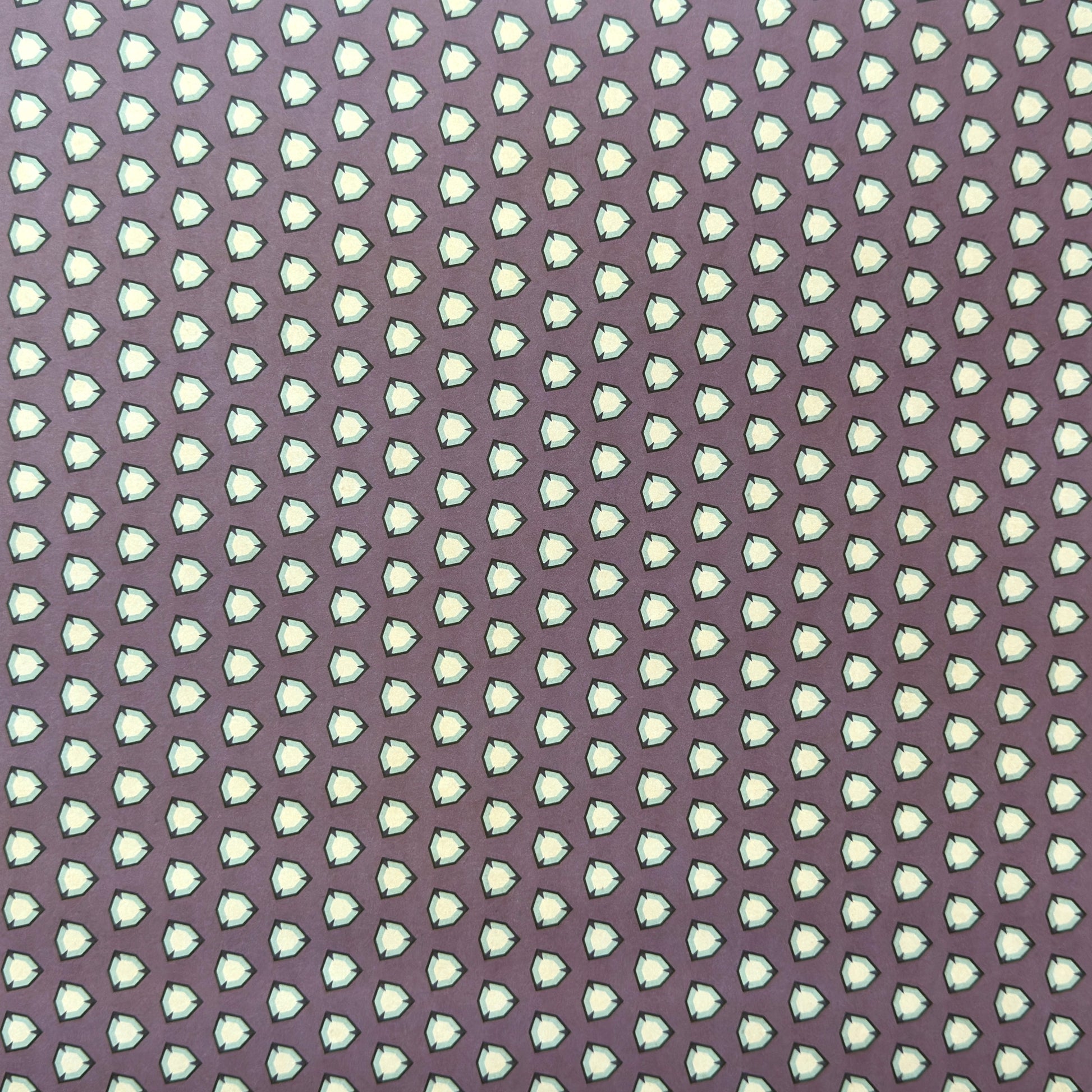 purple wrapping paper with a geometric pattern in white and black