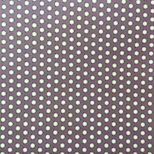 purple wrapping paper with a geometric pattern in white and black