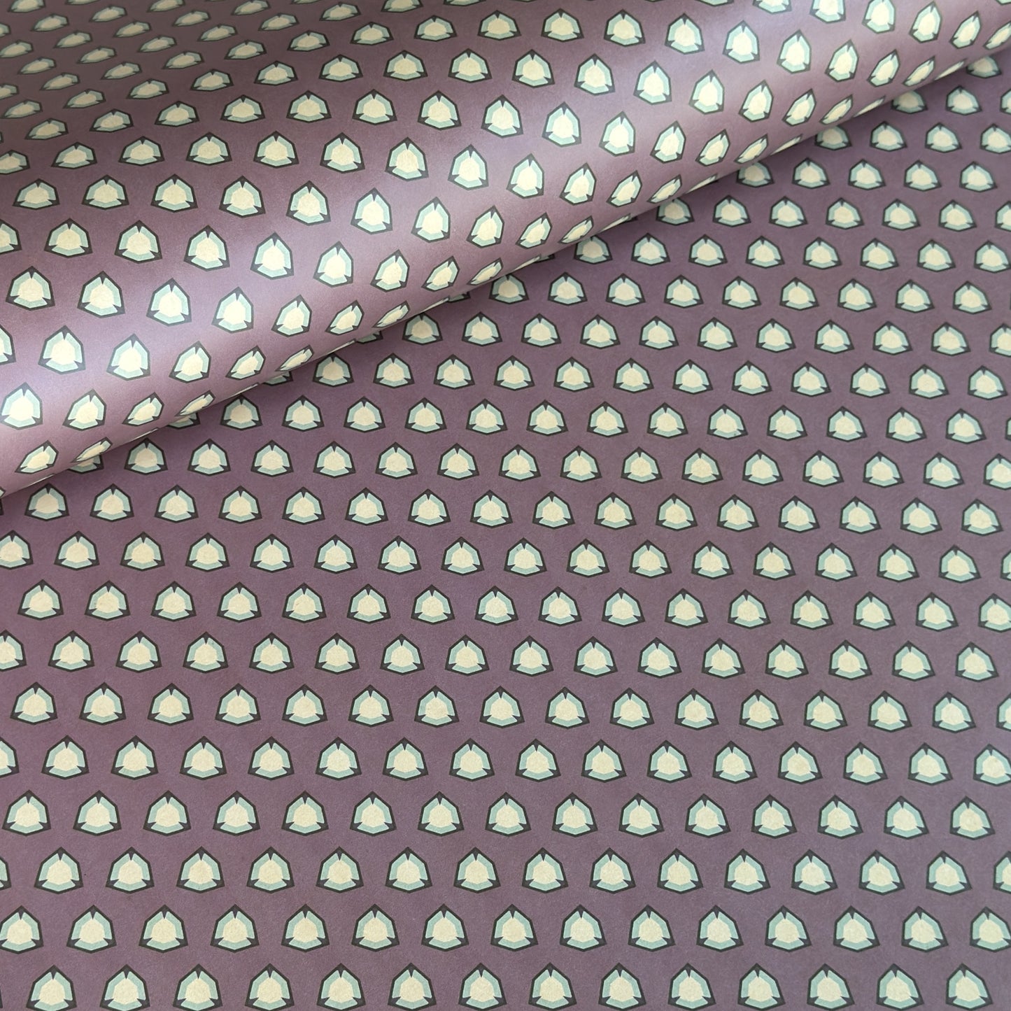 purple wrapping paper with a geometric pattern in white and black
