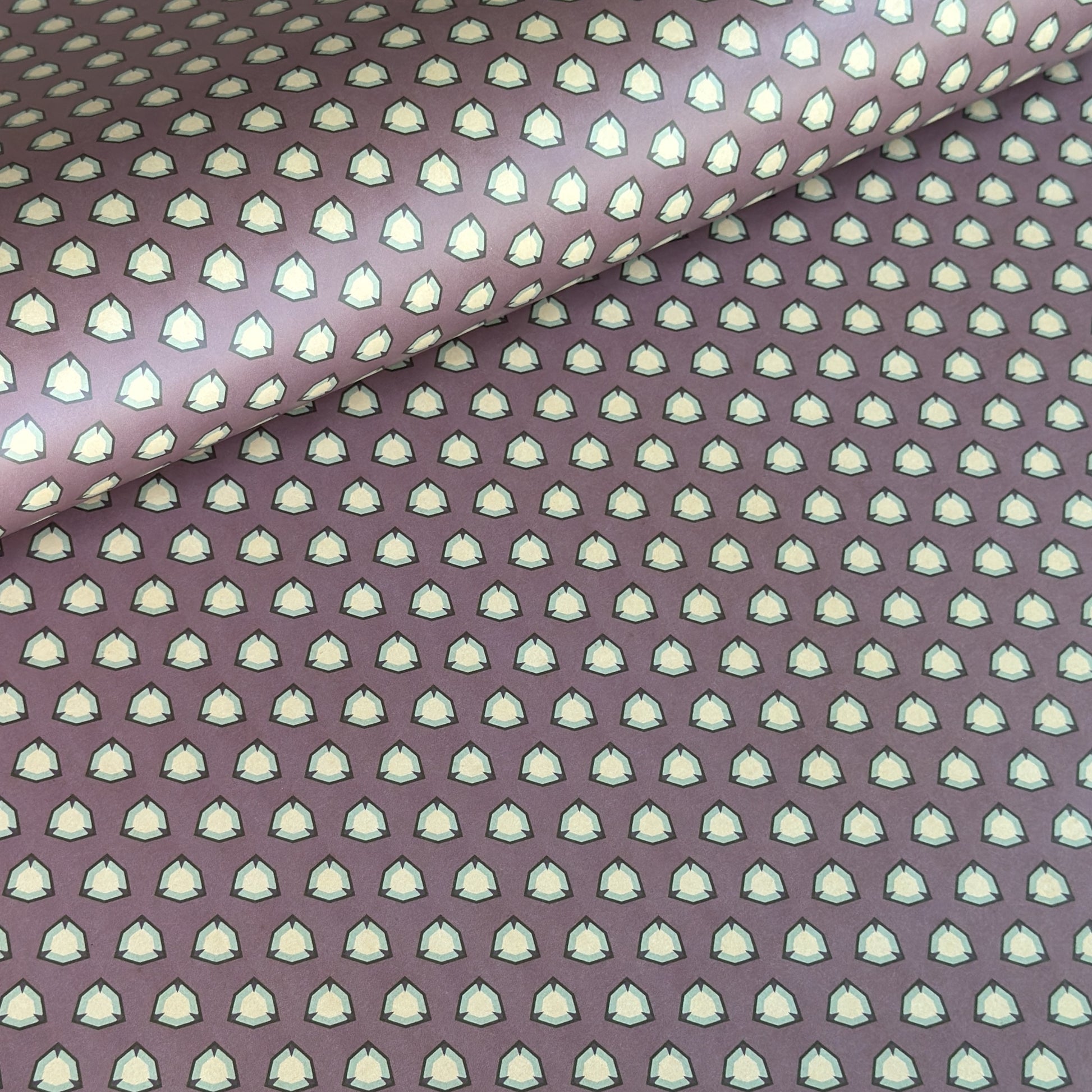 purple wrapping paper with a geometric pattern in white and black