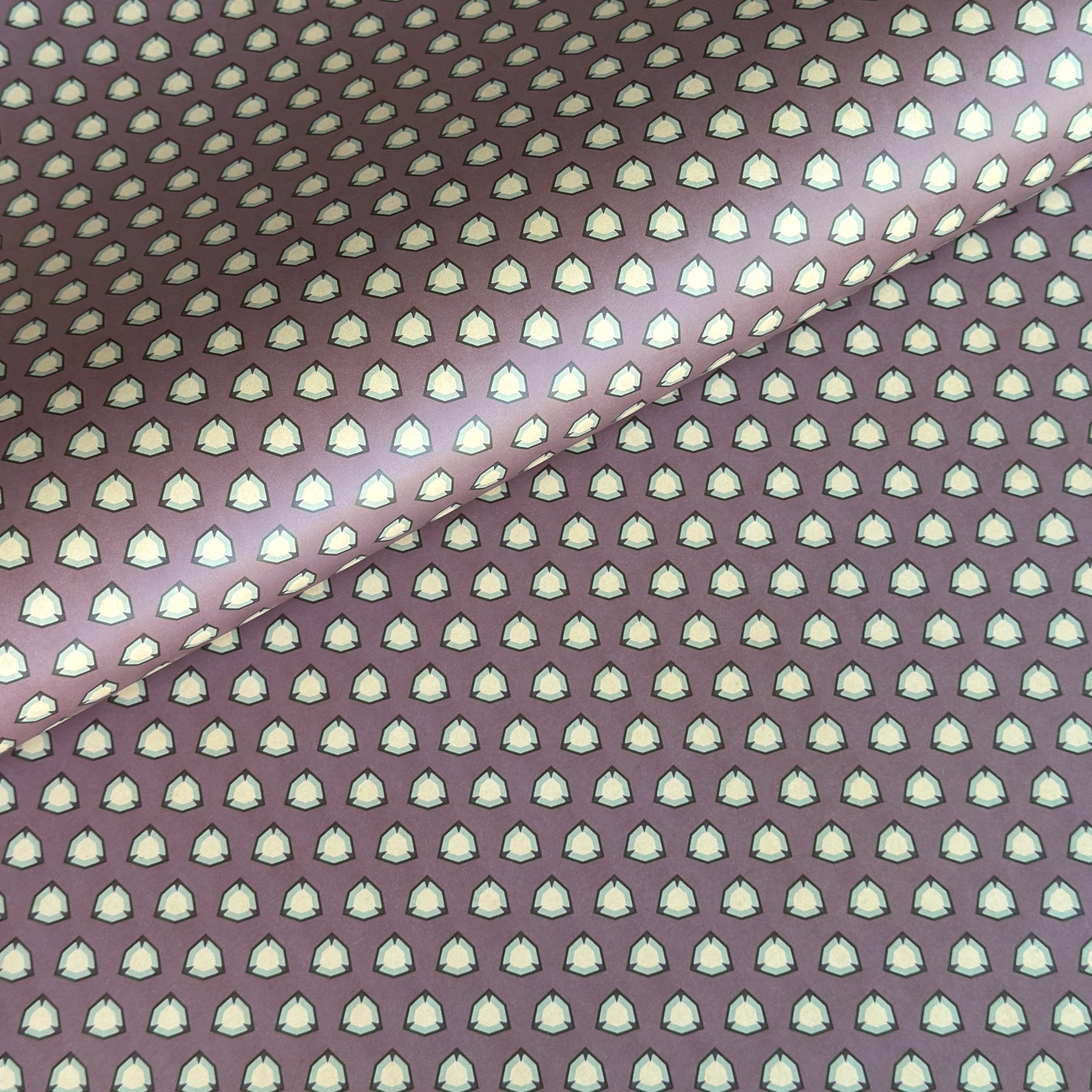 purple wrapping paper with a geometric pattern in white and black