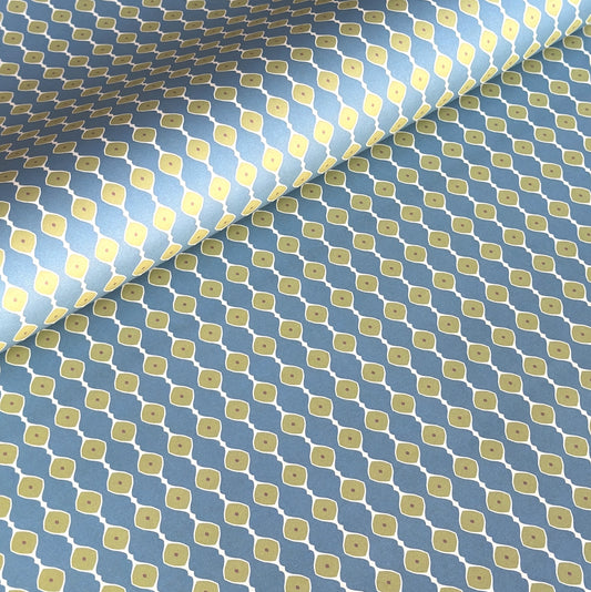 wrapping paper with a geometric pattern of lines of little lime green diamonds on a teal