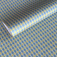wrapping paper with a geometric pattern of lines of little lime green diamonds on a teal