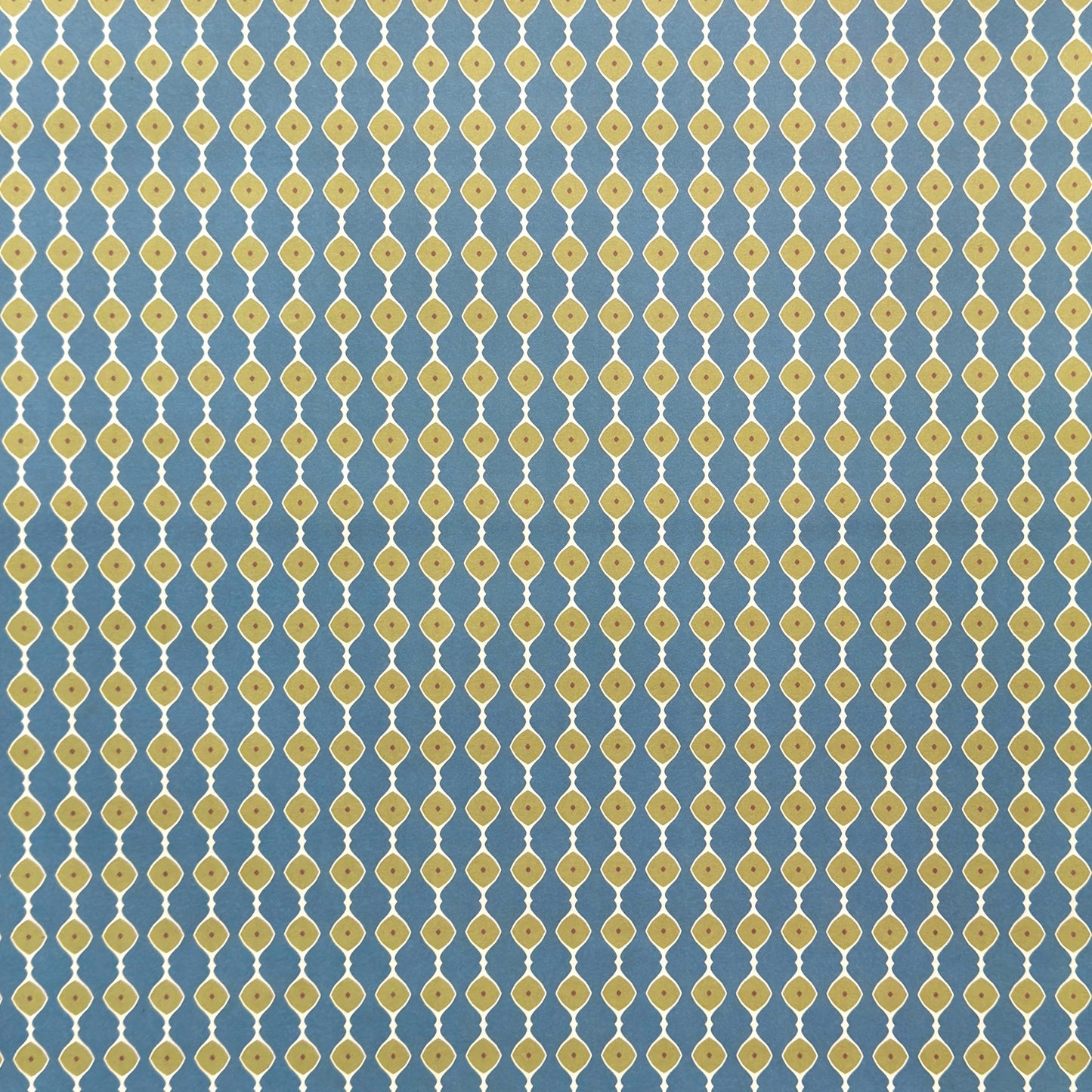 wrapping paper with a geometric pattern of lines of little lime green diamonds on a teal