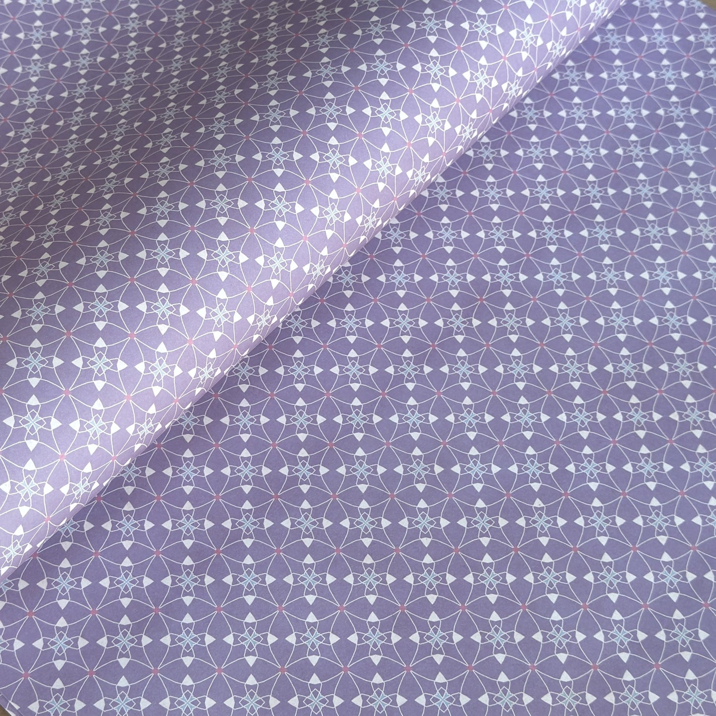 Patterned wrapping paper with geometric design on a purple background