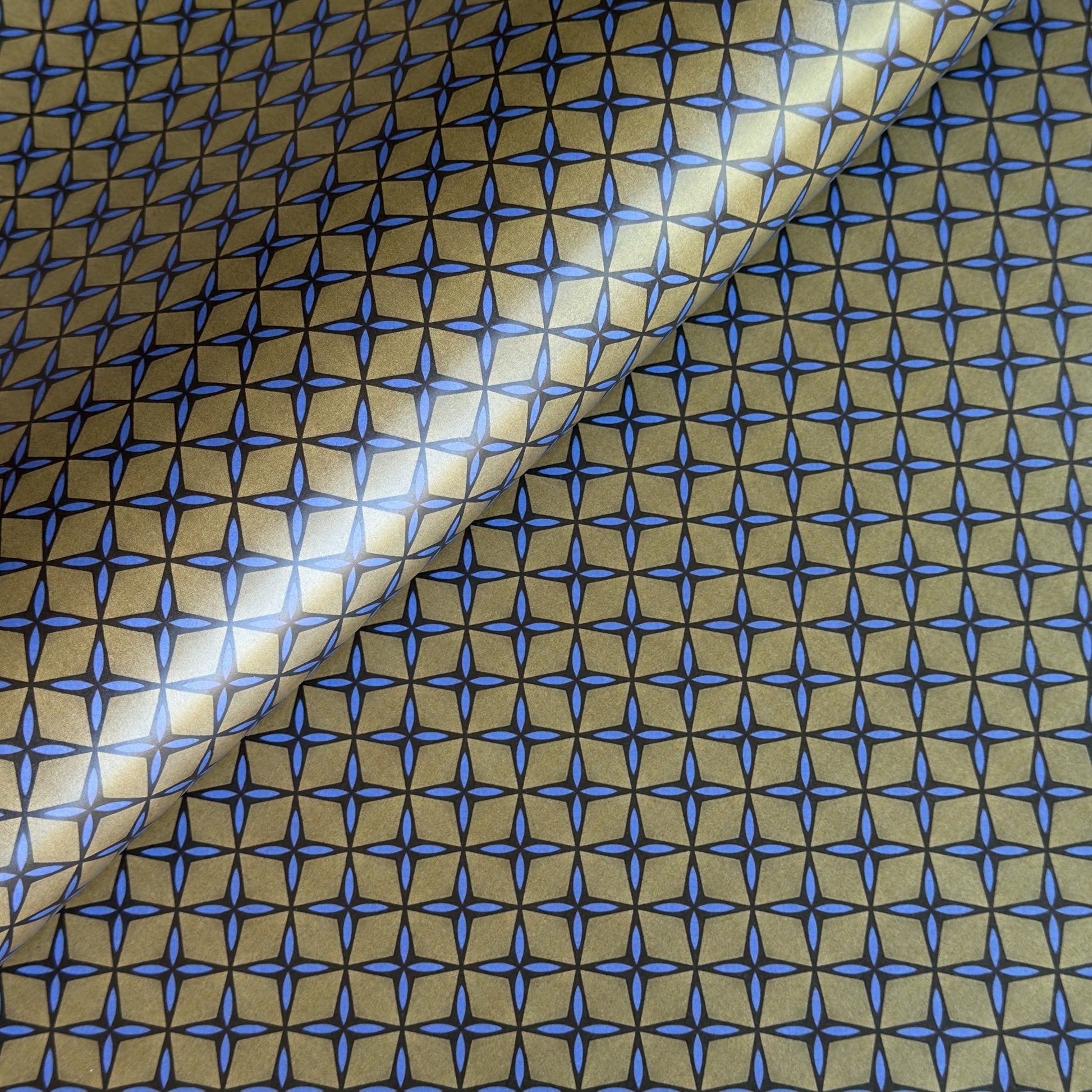 Wrapping paper with blue geometric pattern on a beige background