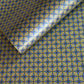 Wrapping paper with blue geometric pattern on a beige background