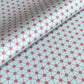 Patterned paper with pink floral shapes on a light blue background