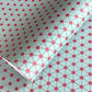Patterned paper with pink floral shapes on a light blue background