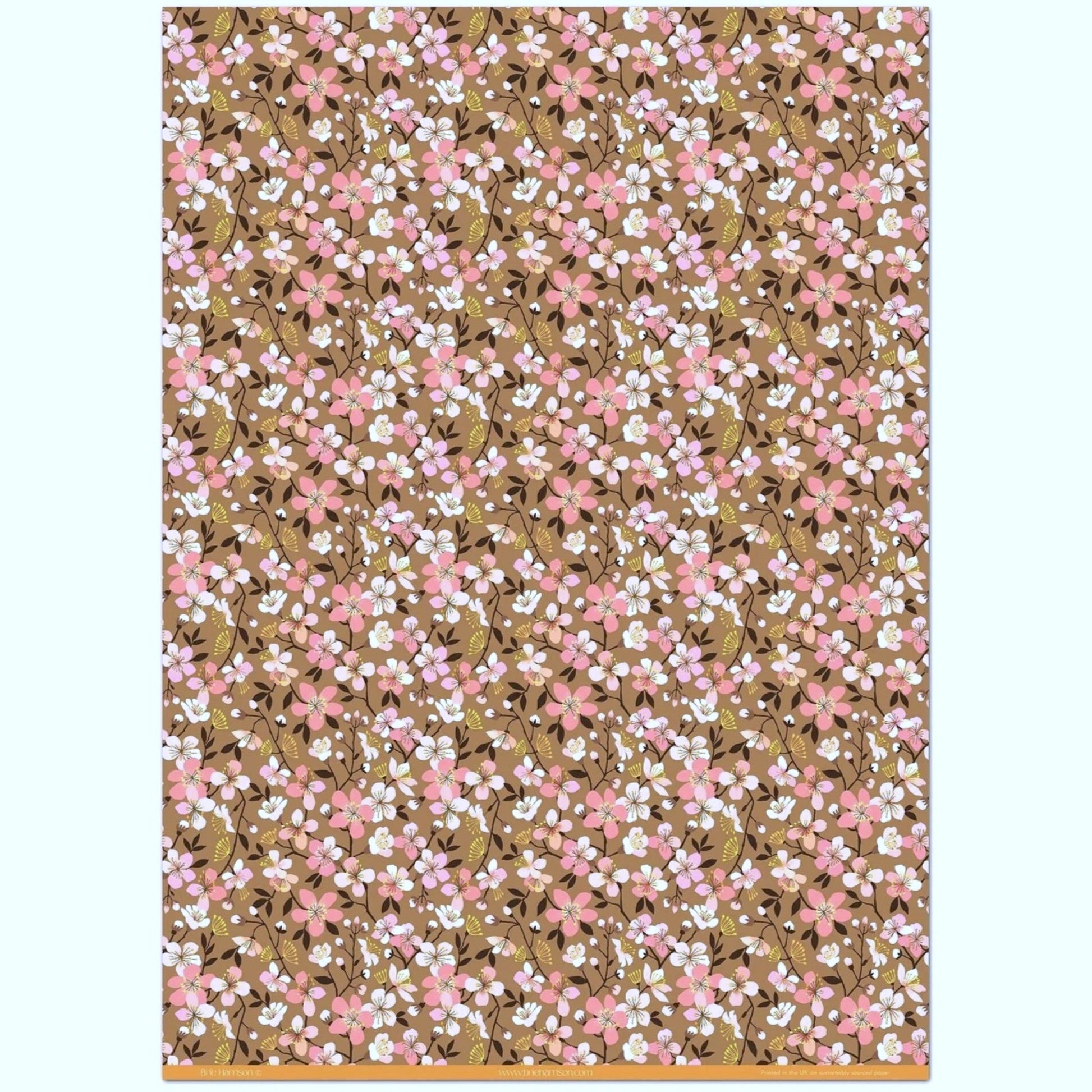 Cherry blossom patterned wrapping paper in pink, white and yellow on brown background